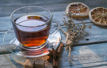 Cup of tea and dry twig herb top view