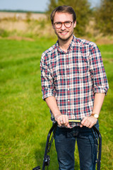 Young man mowing the grass