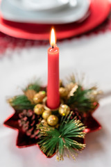 Obraz na płótnie Canvas Close up on burning chrismas candle decoration - christmas, advent, celebration concept