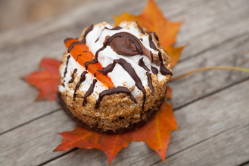 sweet cake and autumn yellow maple leaf