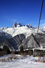 Chair-lift at ski resort and Mount Ushba in sun day