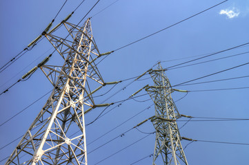 High voltage electrical overhead lines on blue sky