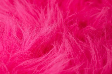 Pink plush fabric horizontal. Very soft polyester textile made of synthetic fibers with long hairs. Macro close up material photography.