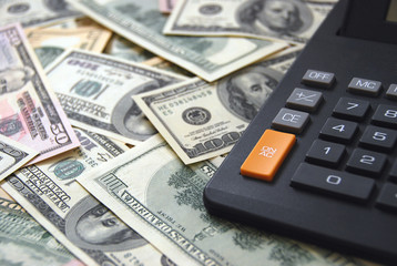 Calculator on money background