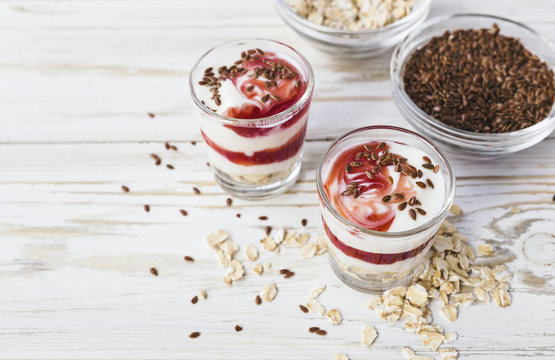 Homemade yogurt with berry jam, linseed and oat flakes