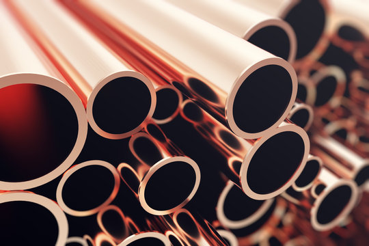 Industry business production and heavy metallurgical industrial products, many shiny steel pipes, industrial background, manufacturing business production concept, copper pipes with selective focus