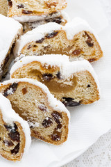 Christmas Stollen with marzipan on a plate, closeup vertical
