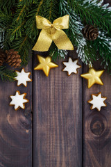 dark wooden background with fir branches and decorations