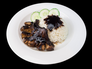 Grilled chicken teriyaki with rice and vegetables on a white plate isolated on the black background with clipping path
