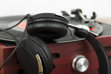 Fototapeta na wymiar Headphones on an old retro record player