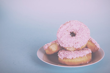 Iced doughnut on a light blue background Vintage Retro Filter.