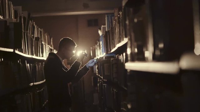 Student with glasses came to the library at night