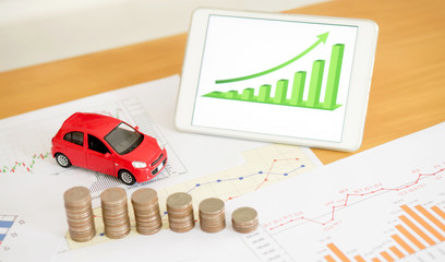 Photo of document some graphics with calculator and car and mone