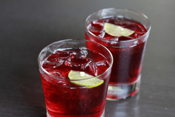 Splash in a glass of red lemonade isolated on white background