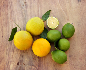 Different refreshing citrus fruits. Cocktail ingredients.Fresh fruits citruses on a dark wooden background. Fruit set.Green lemon