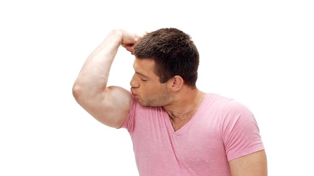 Sportive man showing muscles kissing biceps smiling Slow motion