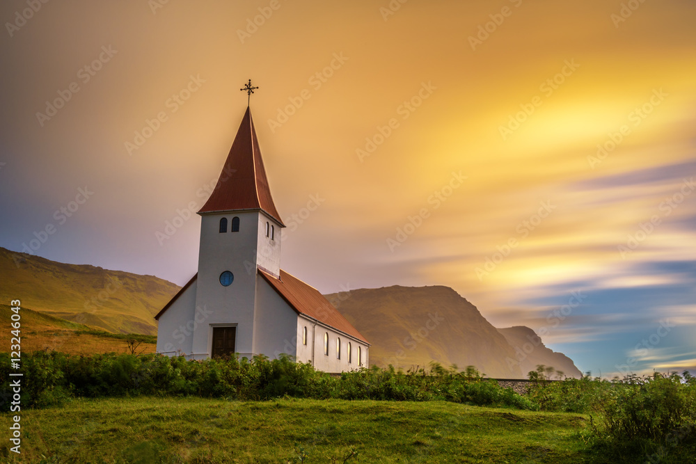 Wall mural sunrise over the lutheran church in vik, iceland