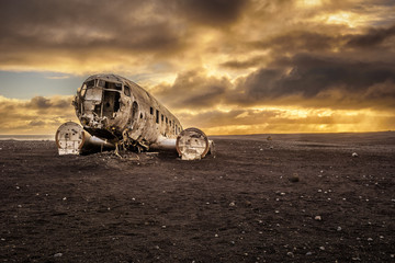 Old crashed plane in Iceland with heavy storm clouds