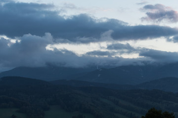 Fototapeta premium Summer landscape in mountains and the dark blue sky with clouds