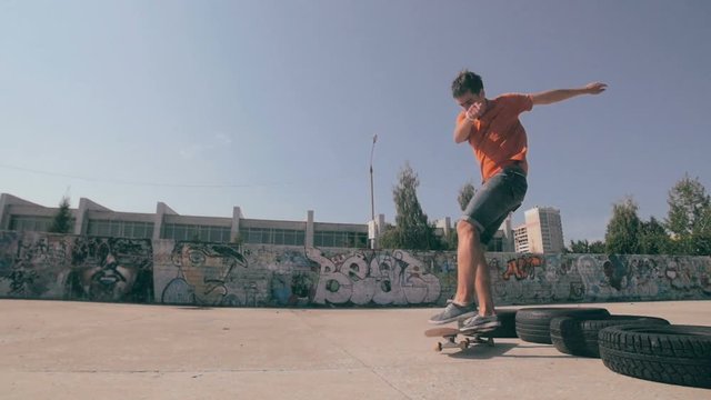Skateboarder doing trick at sunset. HD