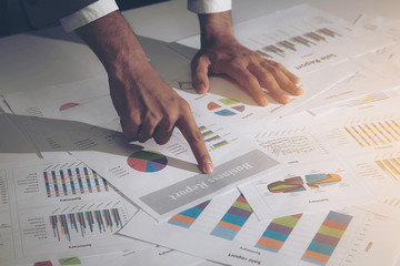 Image of male hand pointing at business report document