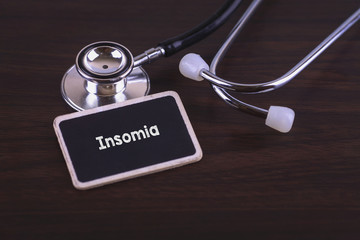 Medical Concept- Insomia  words written on label tag with Stethoscope