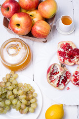 Pieces ripe pomegranate, honey, grapes and apple