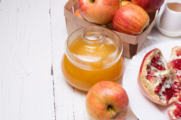 Pieces ripe pomegranate, honey and apple