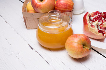 Pieces ripe pomegranate, honey and apple