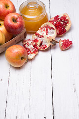 Pieces ripe pomegranate, honey and apple