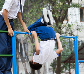 Fototapeta premium Boy training on a horizontal bar