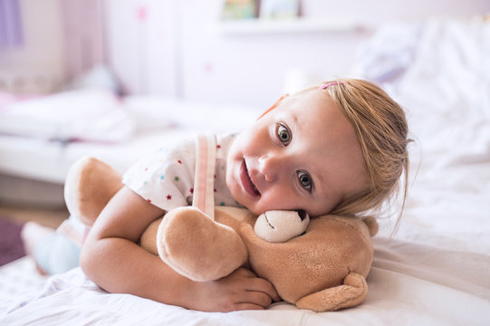 Cute little girl with her teddy bear