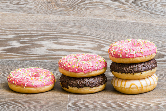 colorful donuts on a wooden background