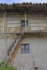 Fototapeta na wymiar An old derelict building in the small Italian village of Oblizza, Friuli Venezia Giulia.