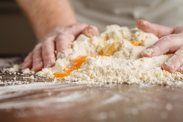Woman who kneads the homemade pasta to prepare lasagna and tagli