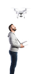 Man with flying drone. Studio shot on white background, isolated