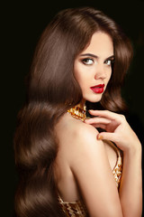 Fototapeta premium Hair. Makeup. Beautiful brunette girl with long wavy shiny hairs