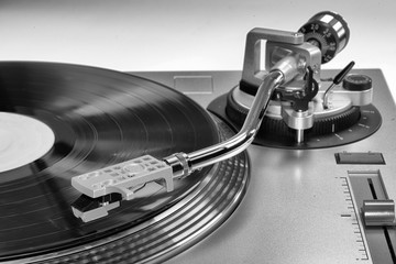 A vinyl record playing on a record player. Vinyl music being played on a turntable.