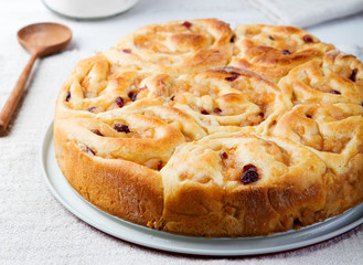 Cinnamon rolls in baking dish on wooden background