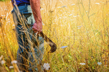 Man on a field holding a knife