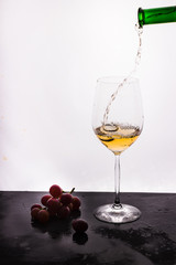 Flowing wine on white background and grape