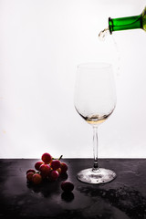 Flowing wine on white background and grape