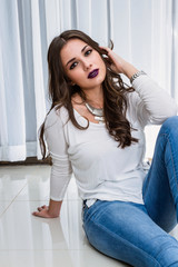 Naklejka premium beautiful woman sitting on the floor