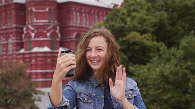 Girl chating on facetime on the phone in front of Kremlin. Russia summer 2016