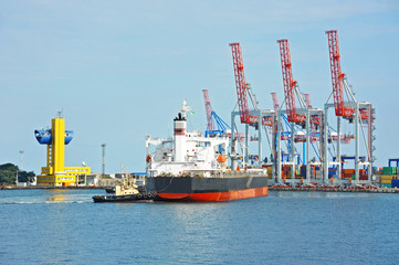 Tugboat assisting bulk cargo ship