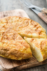 Traditional spanish omelette on rustic wooden table

