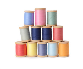 Plenty multicolor threads bobbins isolated on white background. Atelier, sewing accessories backdrop.