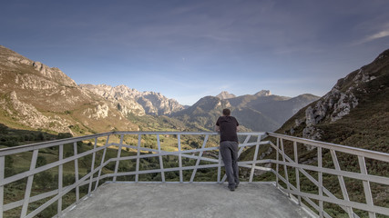 young man viewing the landscape and peaks of national park of picos de Europa in Viewpoint of La...