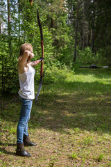 female archer aiming at a target outdoors