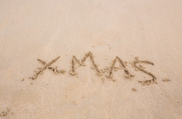 Christmas text on the beach